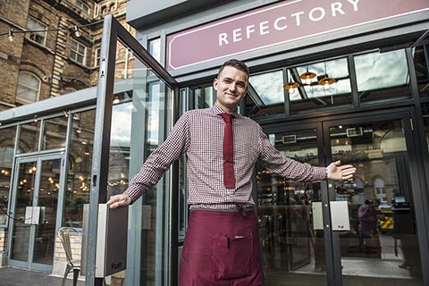 Waiter welcomes you to the Refectory
